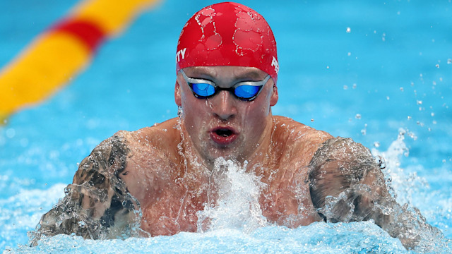 swimmer in pool with red cap