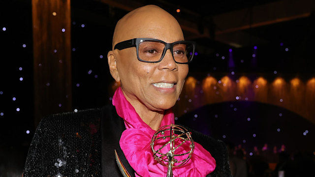 RuPaul holding an Emmy award