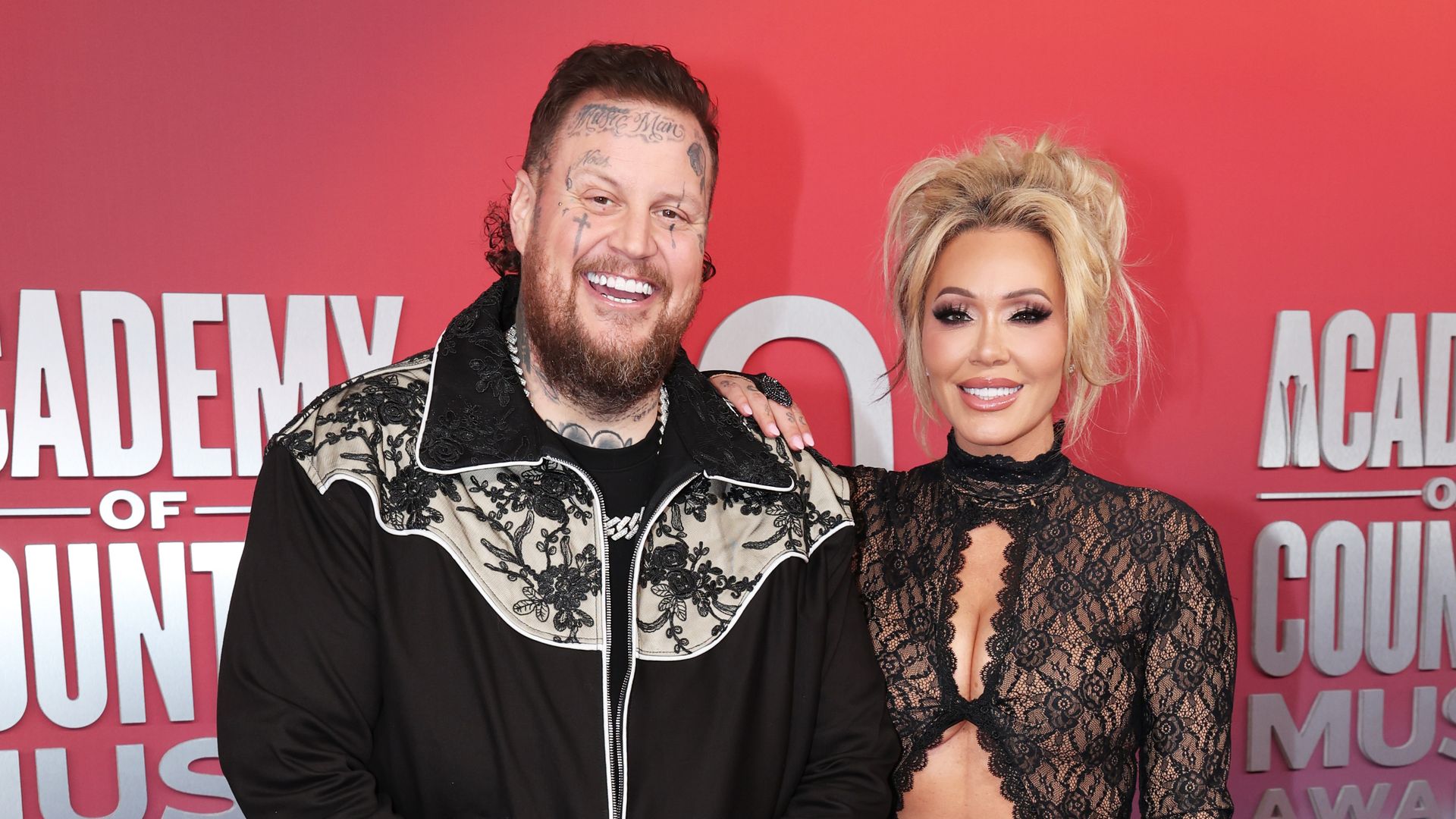 jelly roll and bunnie xo posing together acm awards