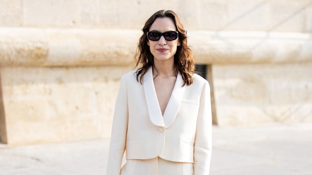 Alexa Chung wears beige suit, black bag, sunglasses outside Dior during the Womenswear Fall/Winter 2024/2025 as part of  Paris Fashion Week 