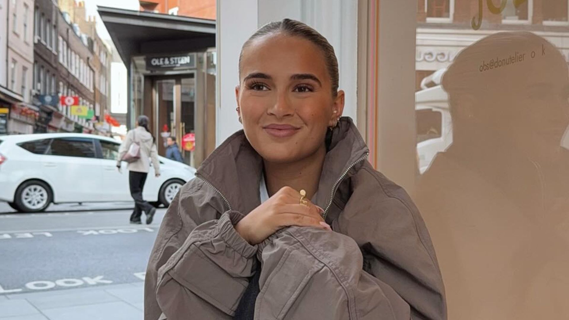 Molly-Mae Hague poses for a photo on her Instagram in a grey jacket and trousers
