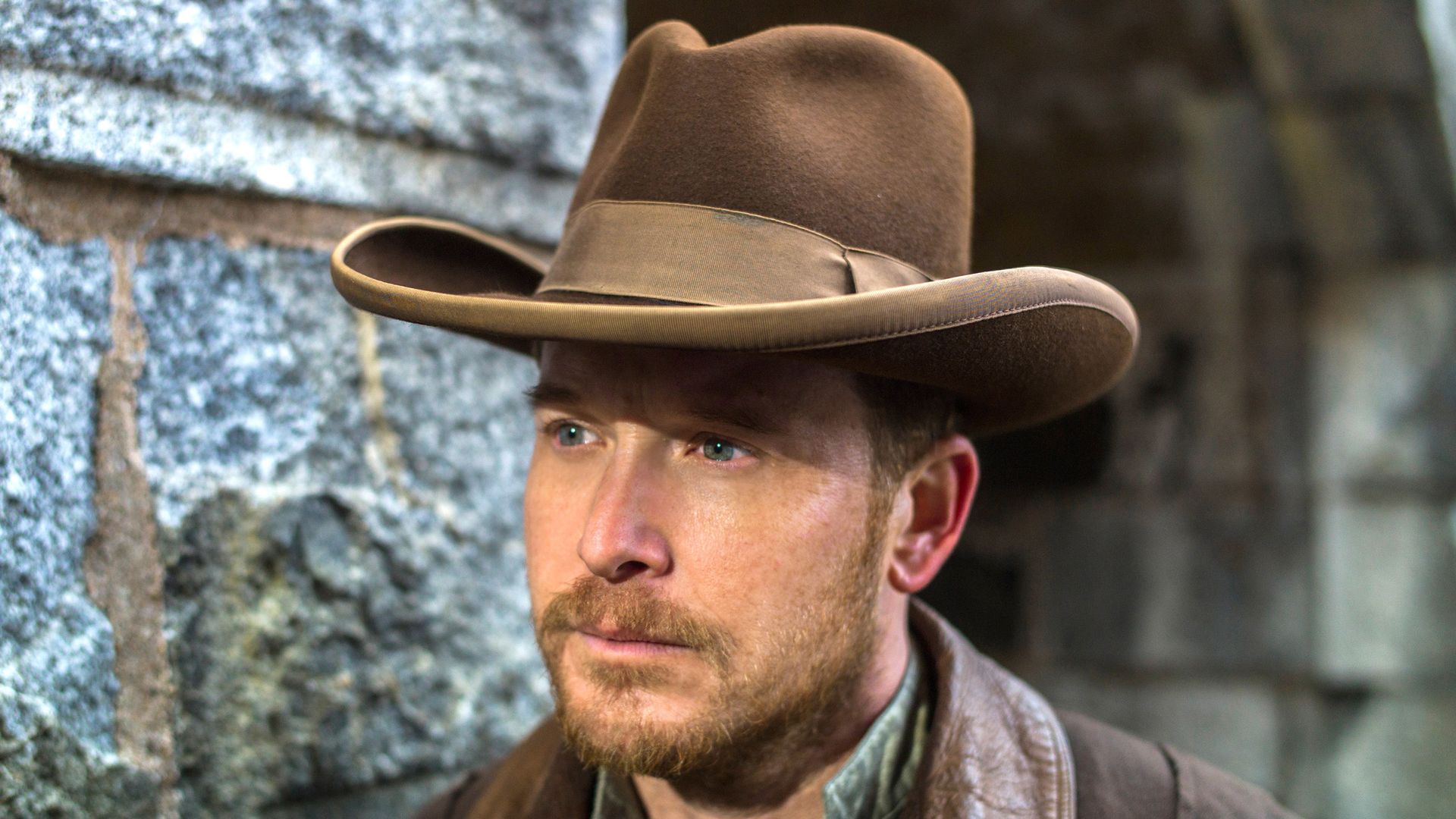 close-up of man wearing cowboy hat