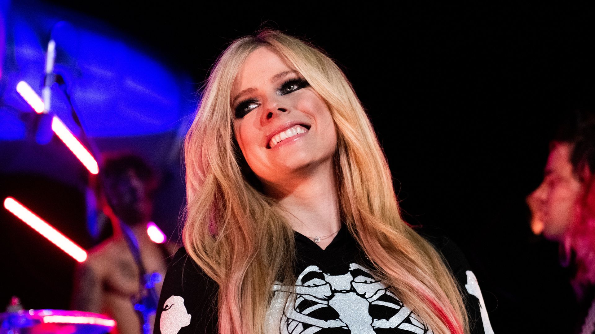 Avril Lavigne rocks fishnets and harness skirt as she's joined by new ...