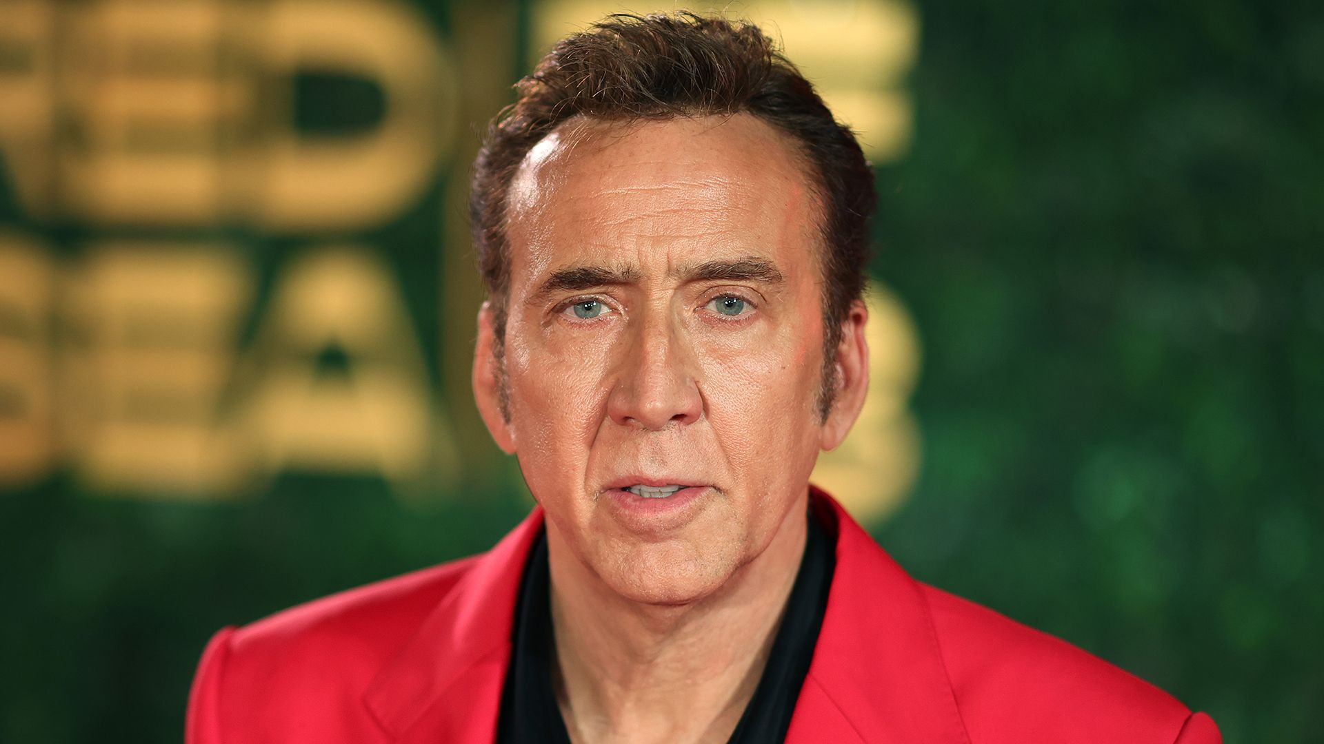 Nicolas Cage wearing a red suit at The Red Sea International Film Festival 2023