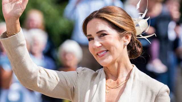 Queen Mary waving in blazer with hair up