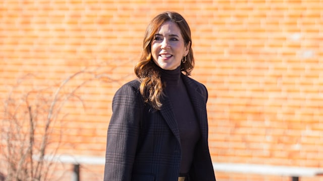 Queen Mary arrives at school wearing suit