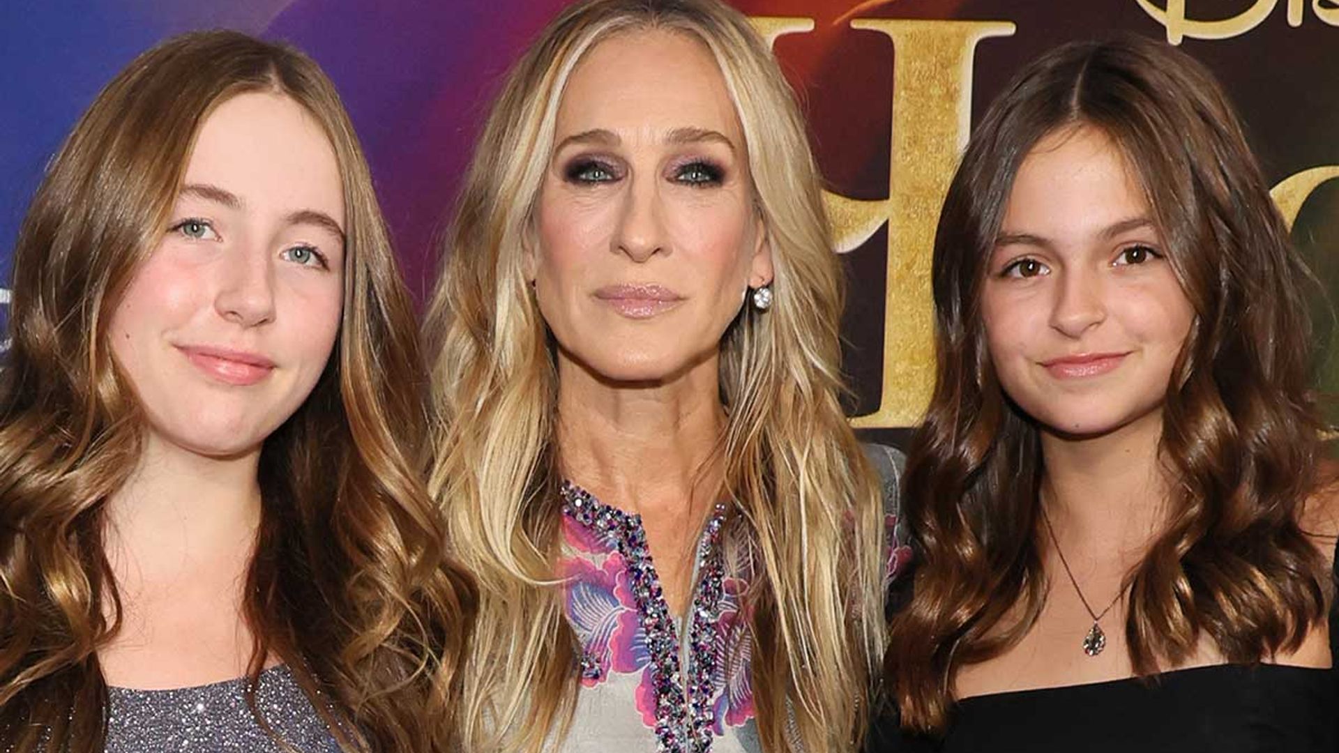 Sarah Jessica Parker supported by lookalike twin daughters in