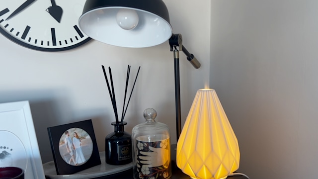 sideboard with scented candle, lamp, electric diffuser