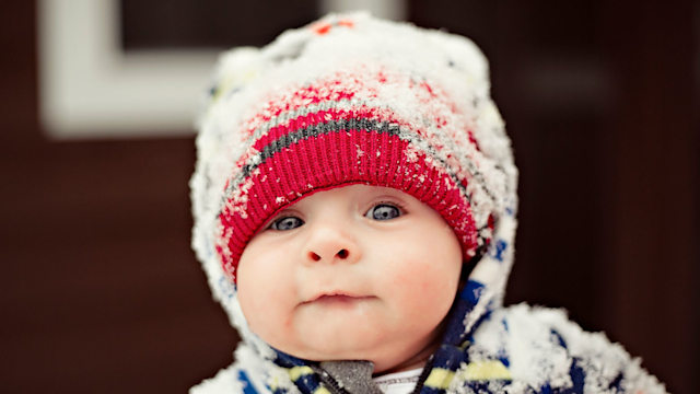 baby wearing snow covered hat