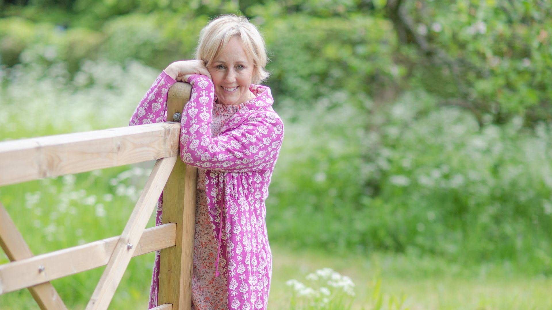Shirlie Kemp looks pretty in pink while holding the garden gate