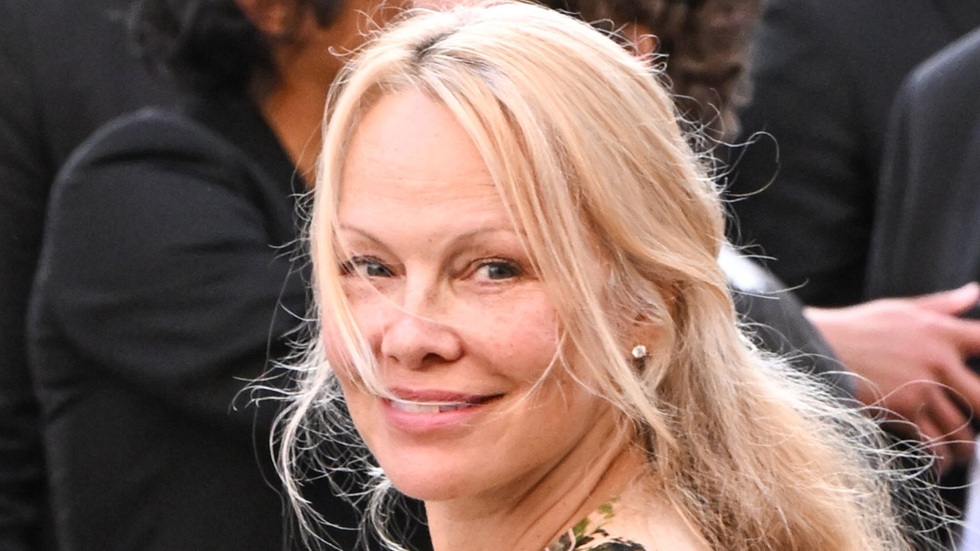 Pamela Anderson in floral dress attends the Victoria Beckham Womenswear Spring/Summer 2024 show