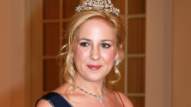 Princess Theodora of Greece in a red dress and a tiara