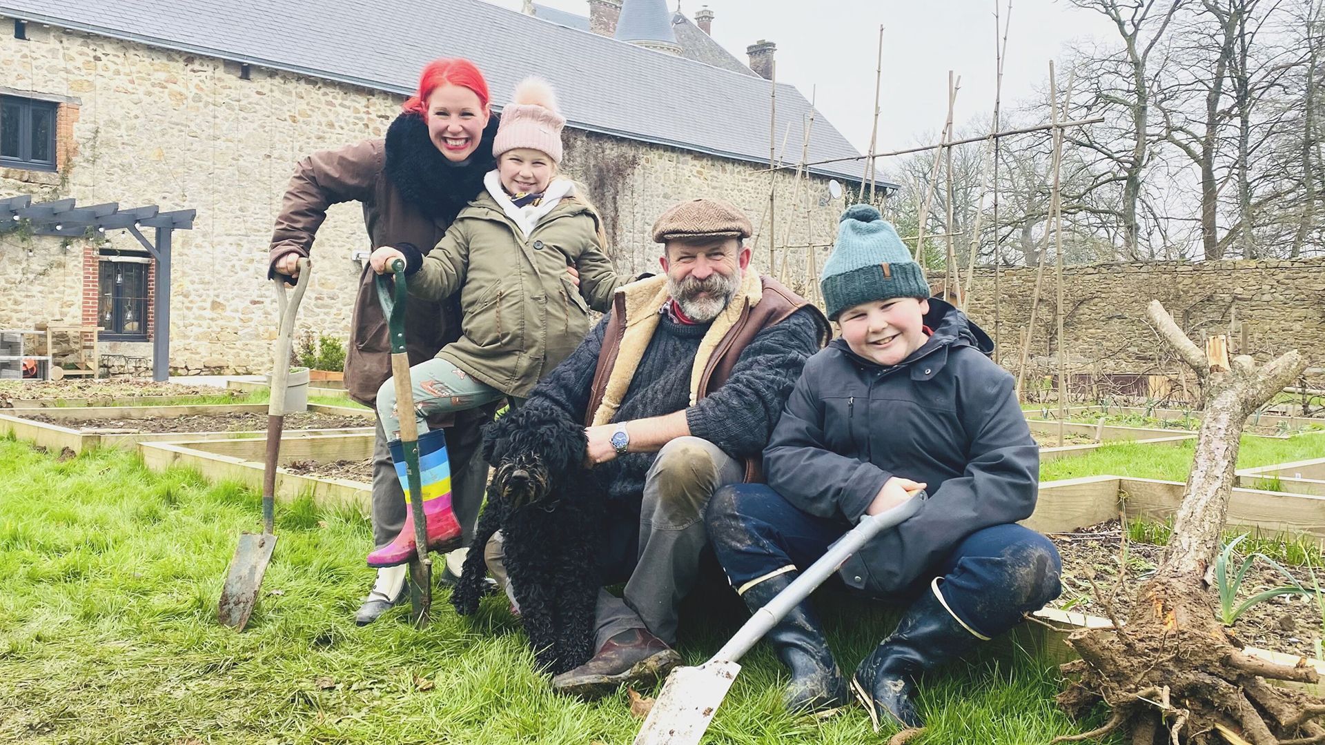 Angel and Dick Strawbridge digging in the garden with their children