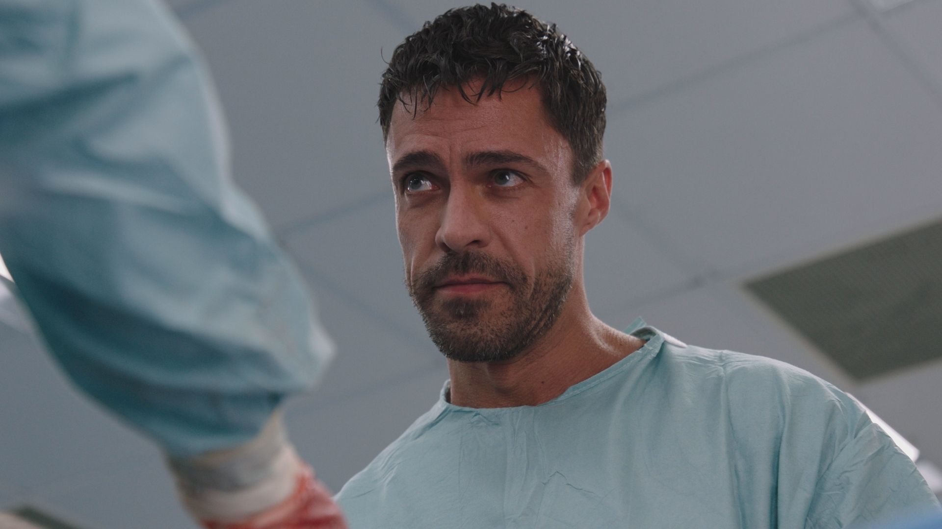 Olly Rix as Flynn Byron in medical gear in Casualty