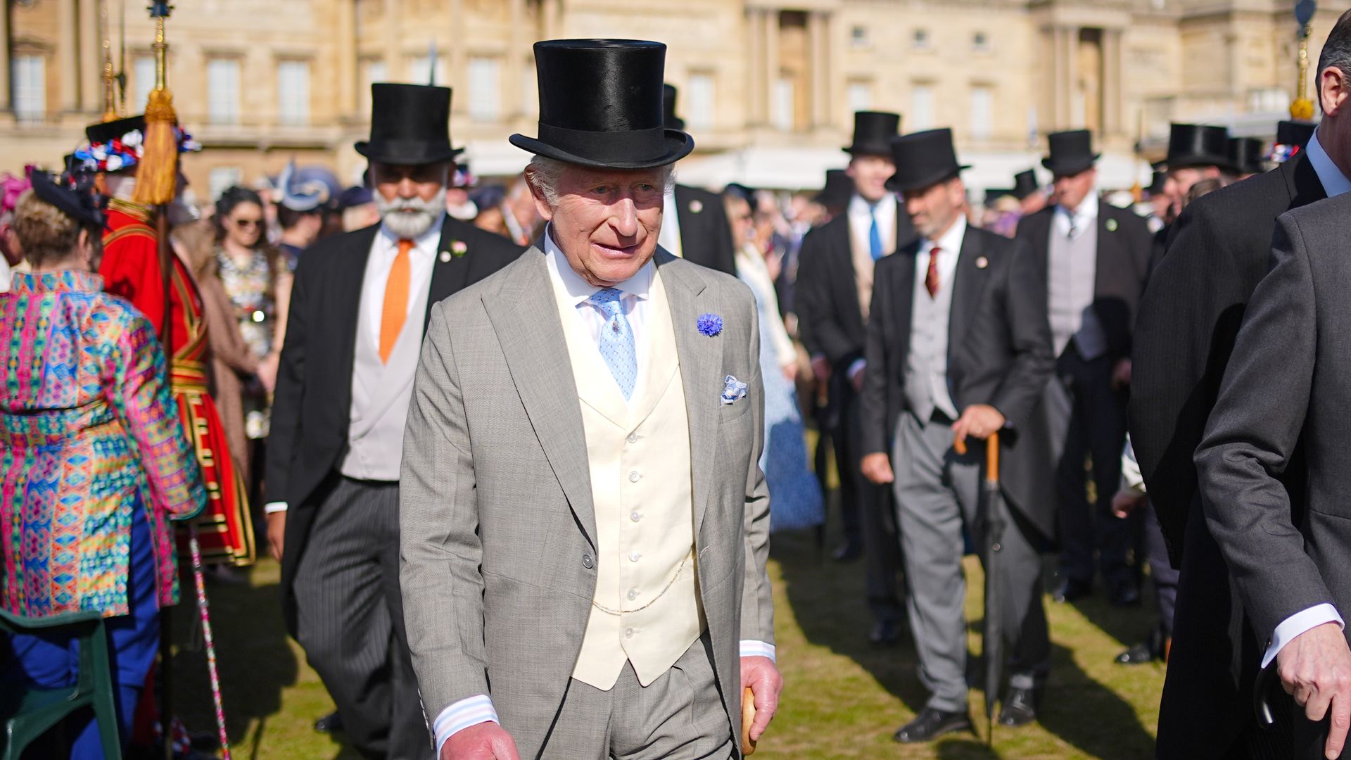 King Charles walking through a crowd of people