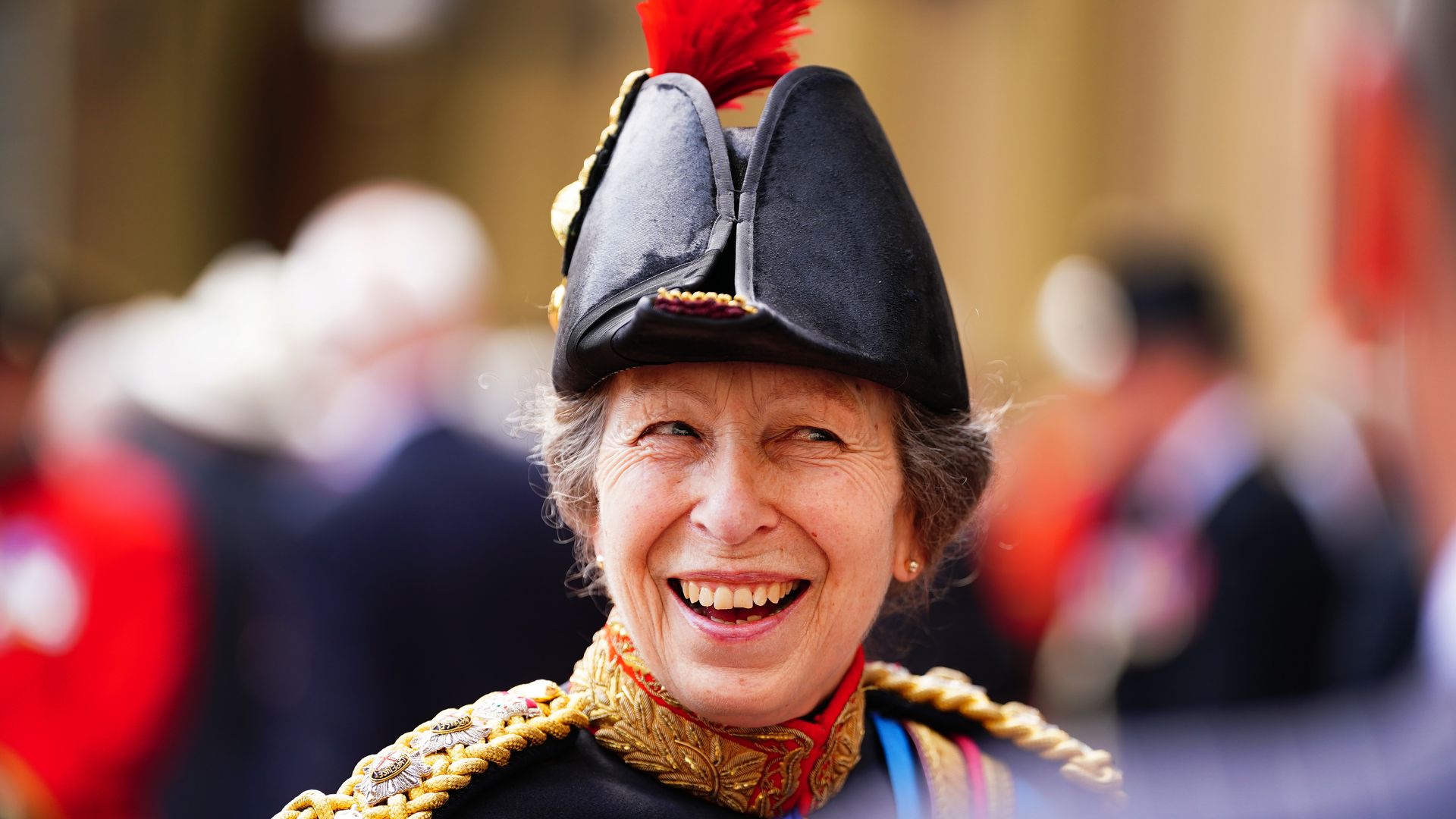 Princess Anne smiling wearing military uniform
