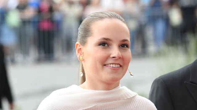 Princess Ingrid Alexandra smiling and wearing a pink shawl over her polka dot dress 