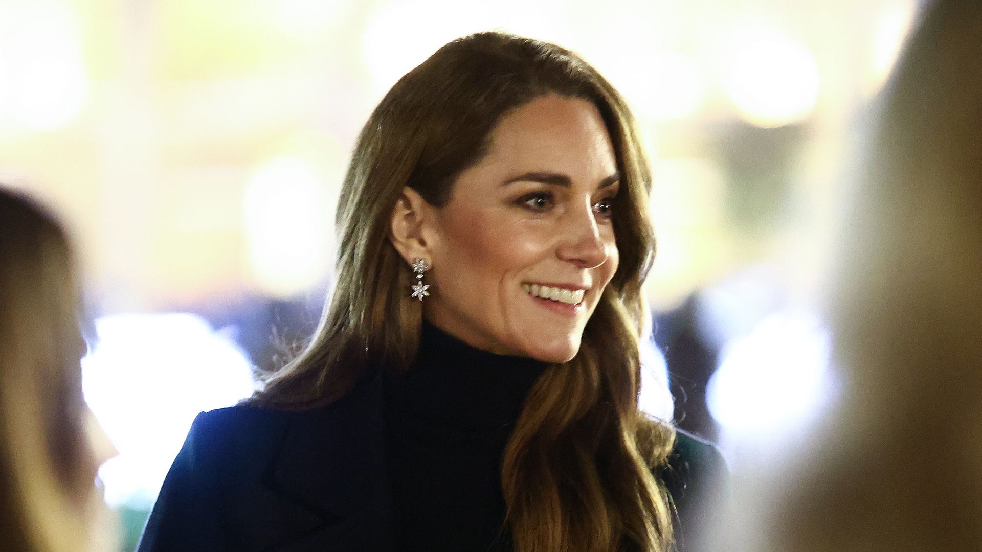 Kate Middleton smiling while wearing snowflake earrings