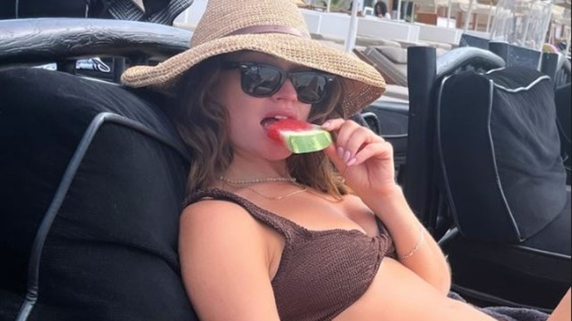 Lily James in brown Hunza G bikini eating watermelon slice