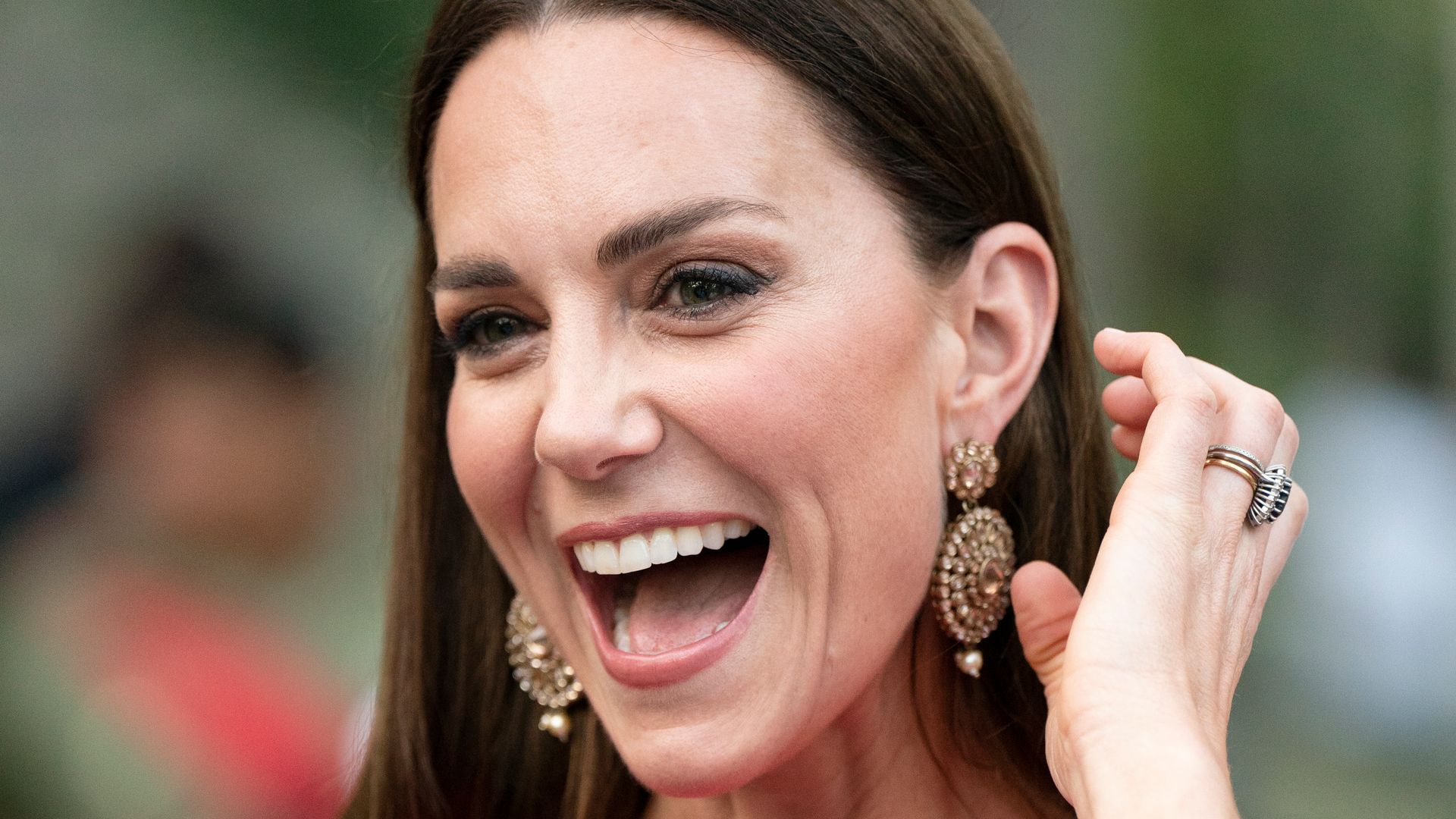 Catherine with mouth open laughing in pink dress