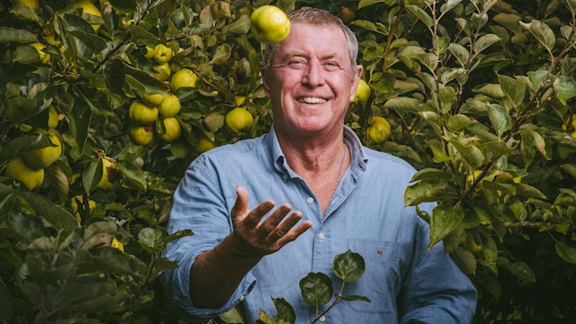 John Nettles standing by an apple tree