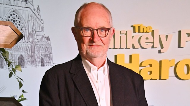 Jim Broadbent smiling at a red carpet event