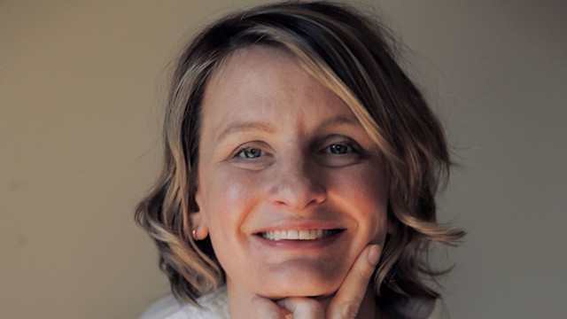 woman smiling in a white shirt 