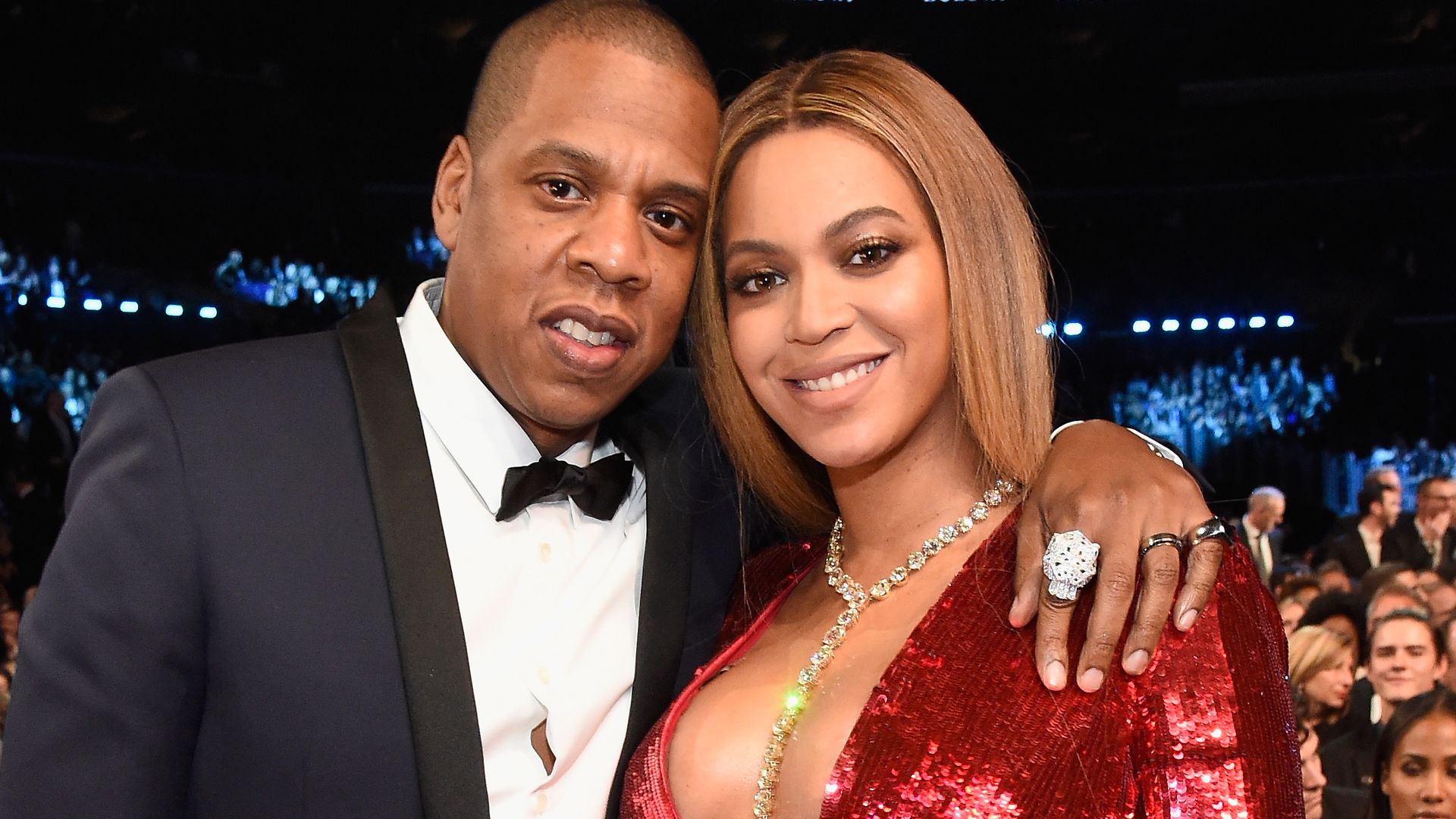 Beyonce and Jay-Z smiling at a fancy event, she is pregnant