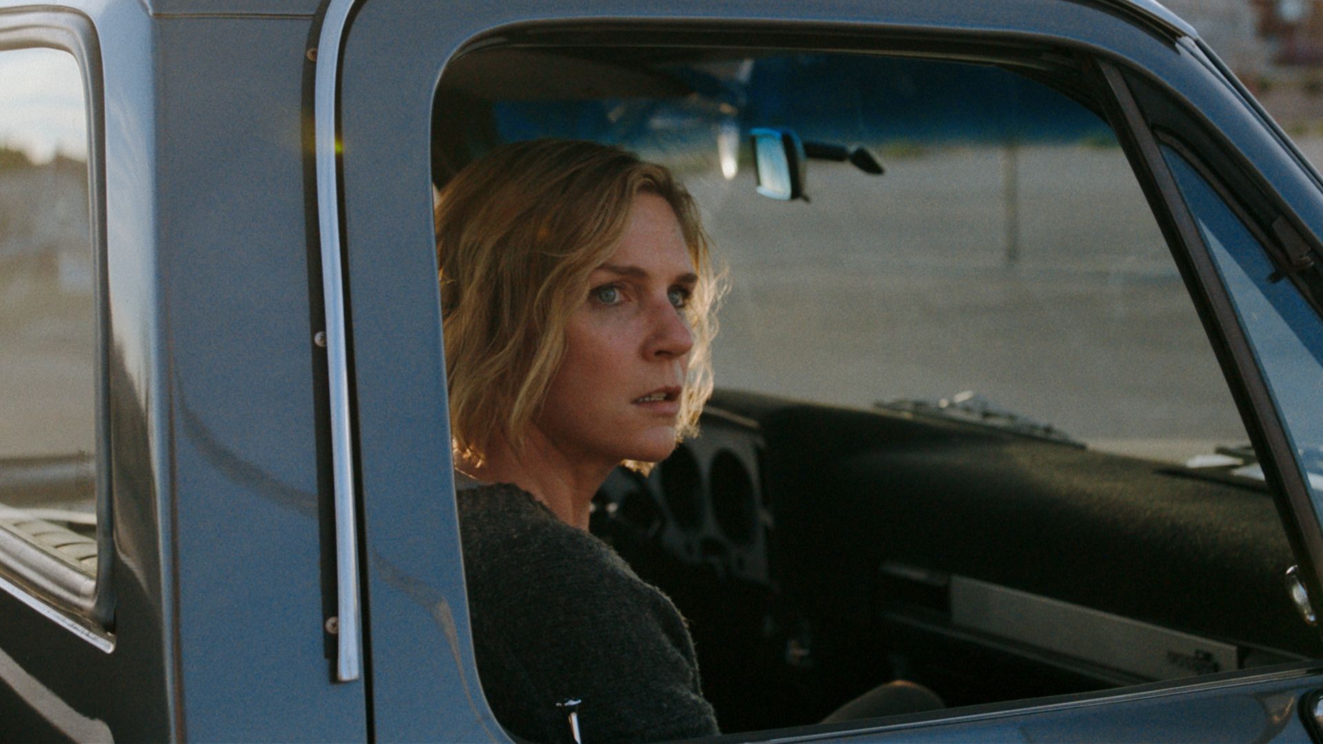 woman sitting in driver's seat of truck 