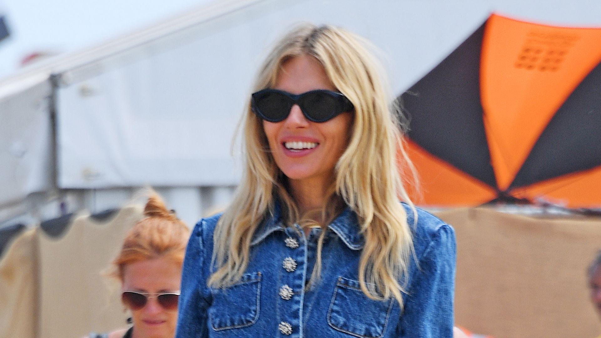 Sienna Miller wearing double denim and cowboy boots