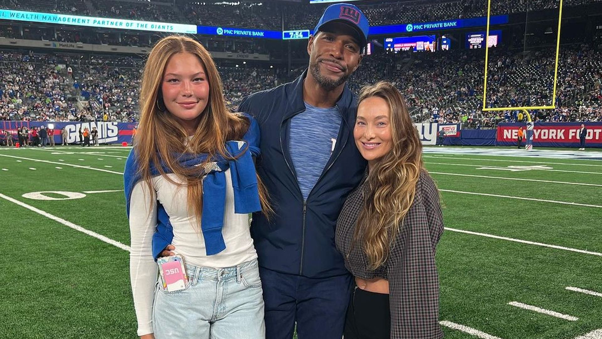 Michael Strahan, his girlfriend, Kayla Quick and his daughter, Isabella watched the Giants game