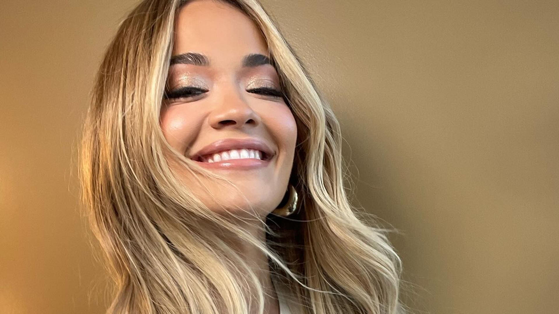 Rita Ora shares a smiling picture of her in a graphic tee 