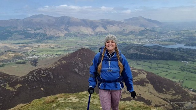 Young woman hiking with a crutch