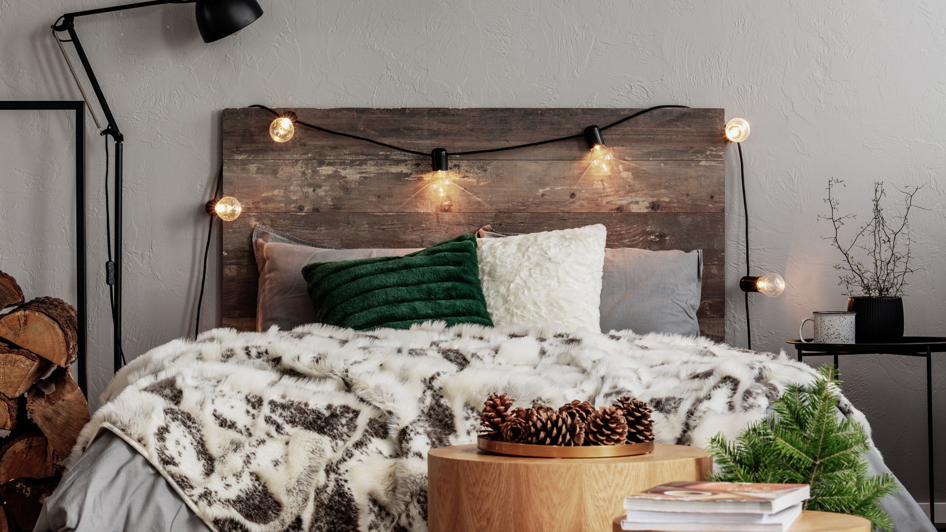 cosy bedroom with wooden headboard and fairy lights 