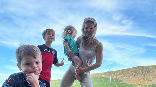 helen skelton posing next to lake with kids