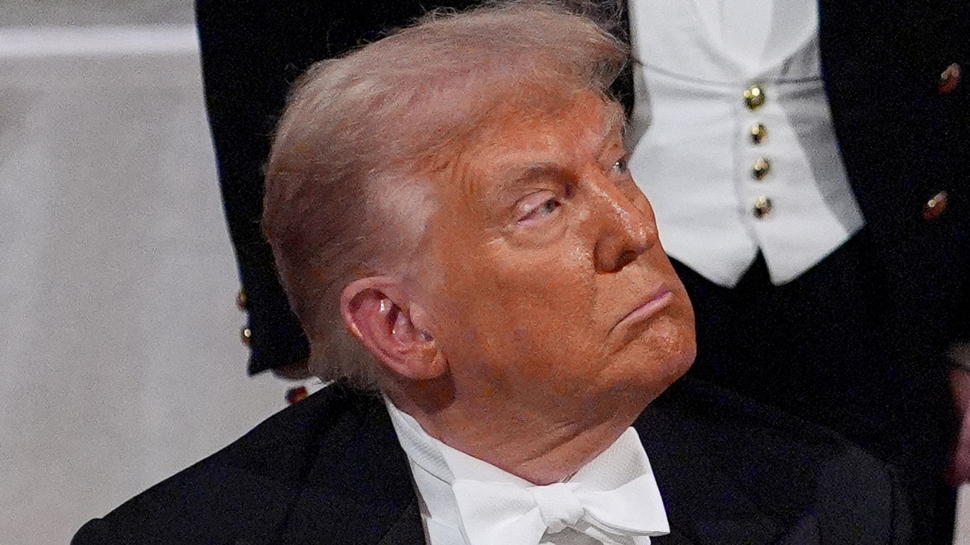 US President Donald Trump looks on as Britain's King Charles III delivers a speech during a State Banquet at Windsor Castle, in Windsor, on September 17, 2025, during the US President's second State Visit. US President Donald Trump arrived in Britain for an unprecedented second State Visit, with the UK government rolling out a royal red carpet welcome to win over the mercurial leader. (Photo by Yui Mok / POOL / AFP) (Photo by YUI MOK/POOL/AFP via Getty Images)          