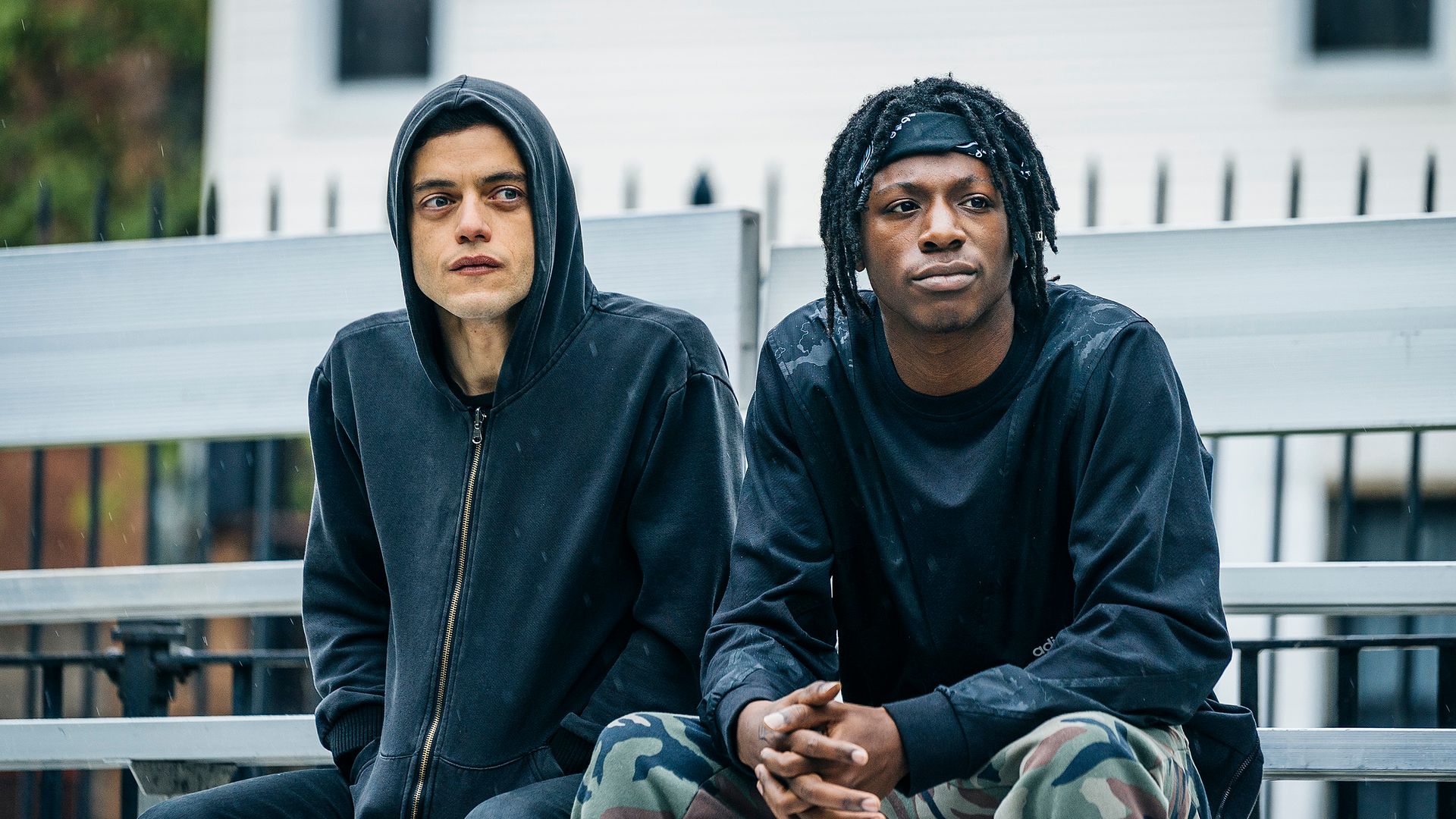 two men sitting on bench 