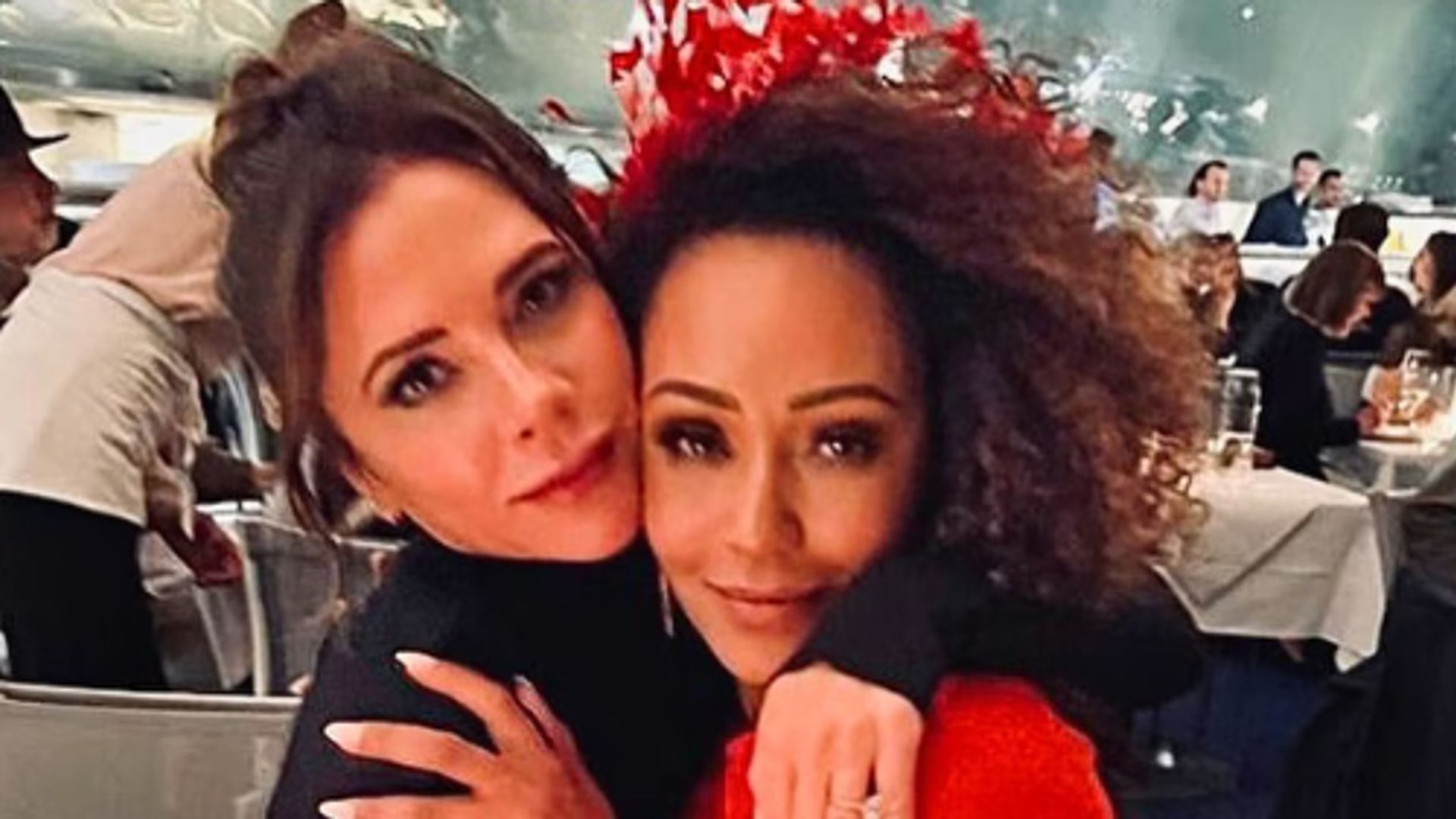 Victoria Beckham and Mel B embracing