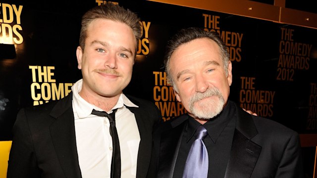 Robin poses with his son, Zachary Pym Williams, on red carpet in 2012