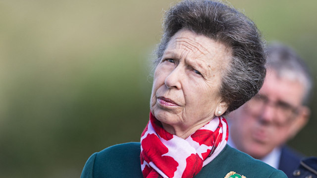 Princess Anne looking perplexed in a green jacket and floral print scarf