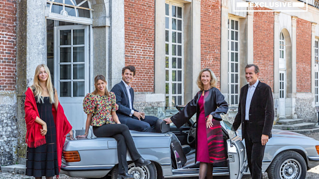 Count and Countess Lepic posing on car bonnet with three childrenin Normandy 