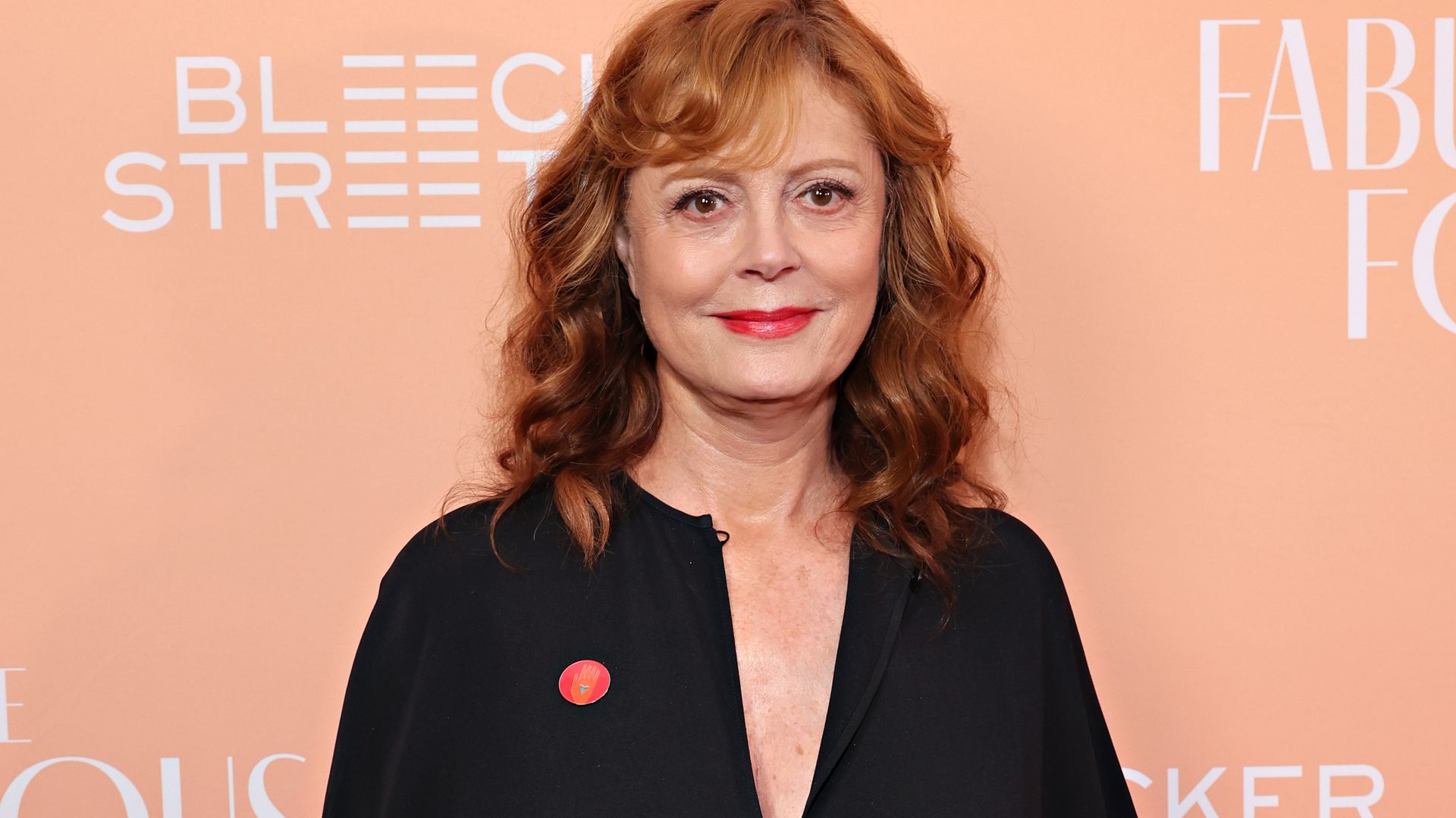 Susan Sarandon is a vision in all white as she cozies up to dashing A-lister