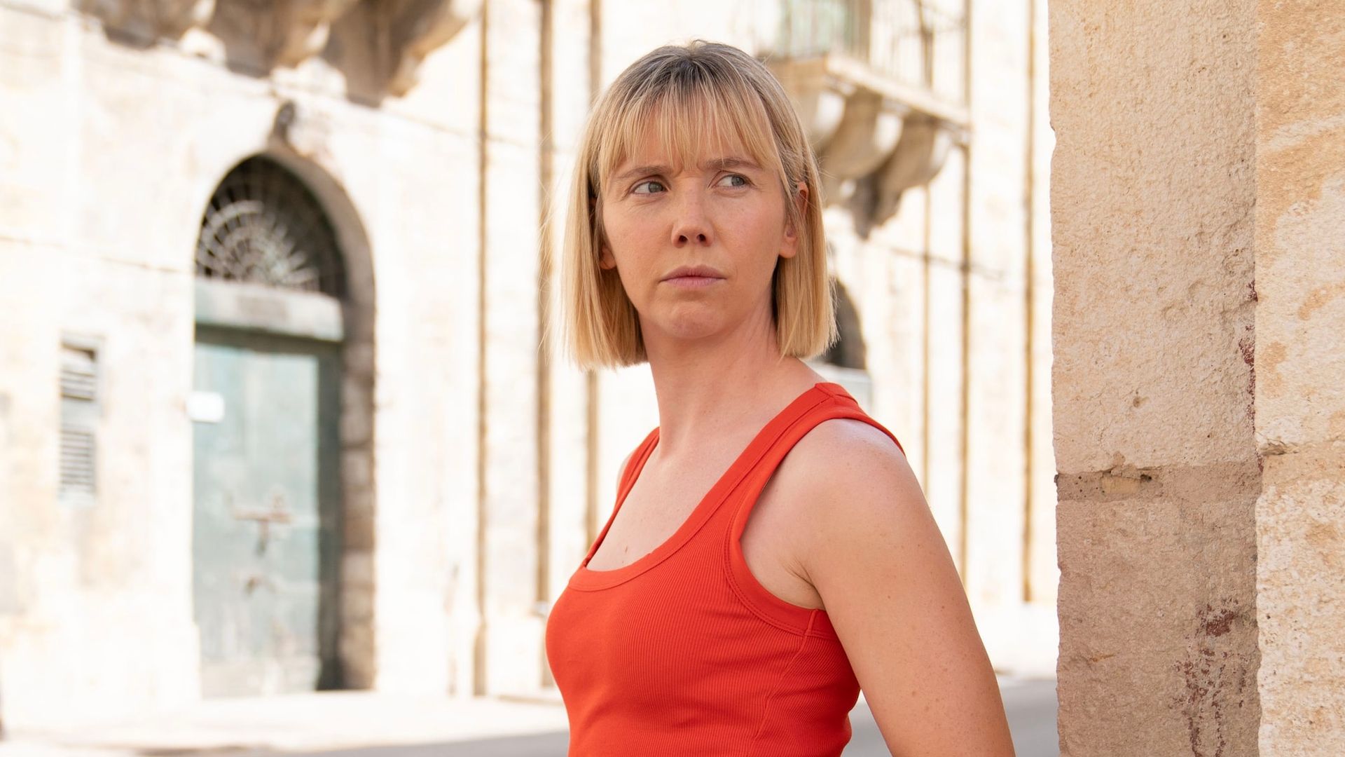 blonde woman standing in street