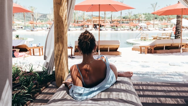 Woman Relaxing on a sunbed at La Reserva Beach Resort, Sotogrande