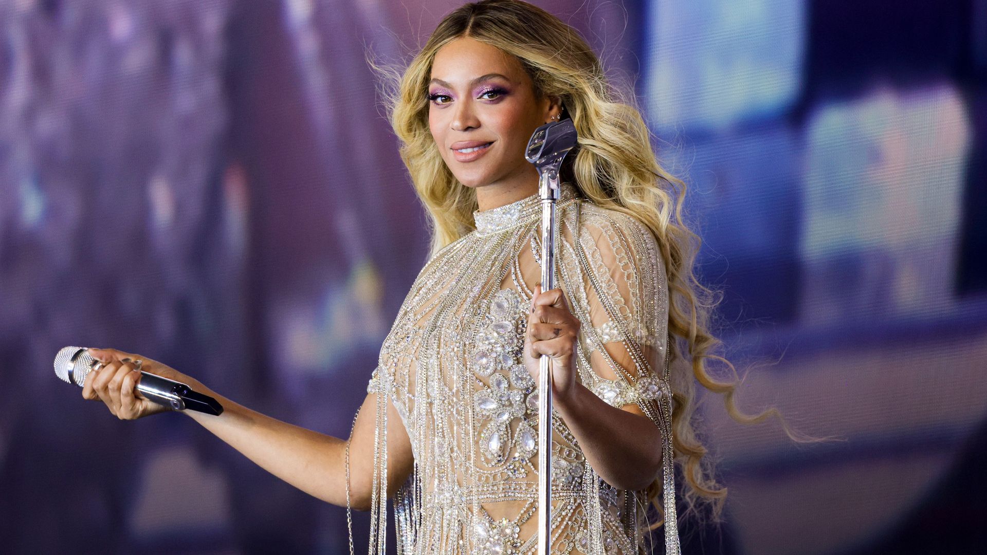 Beyonce performs onstage in silver bejeweled look