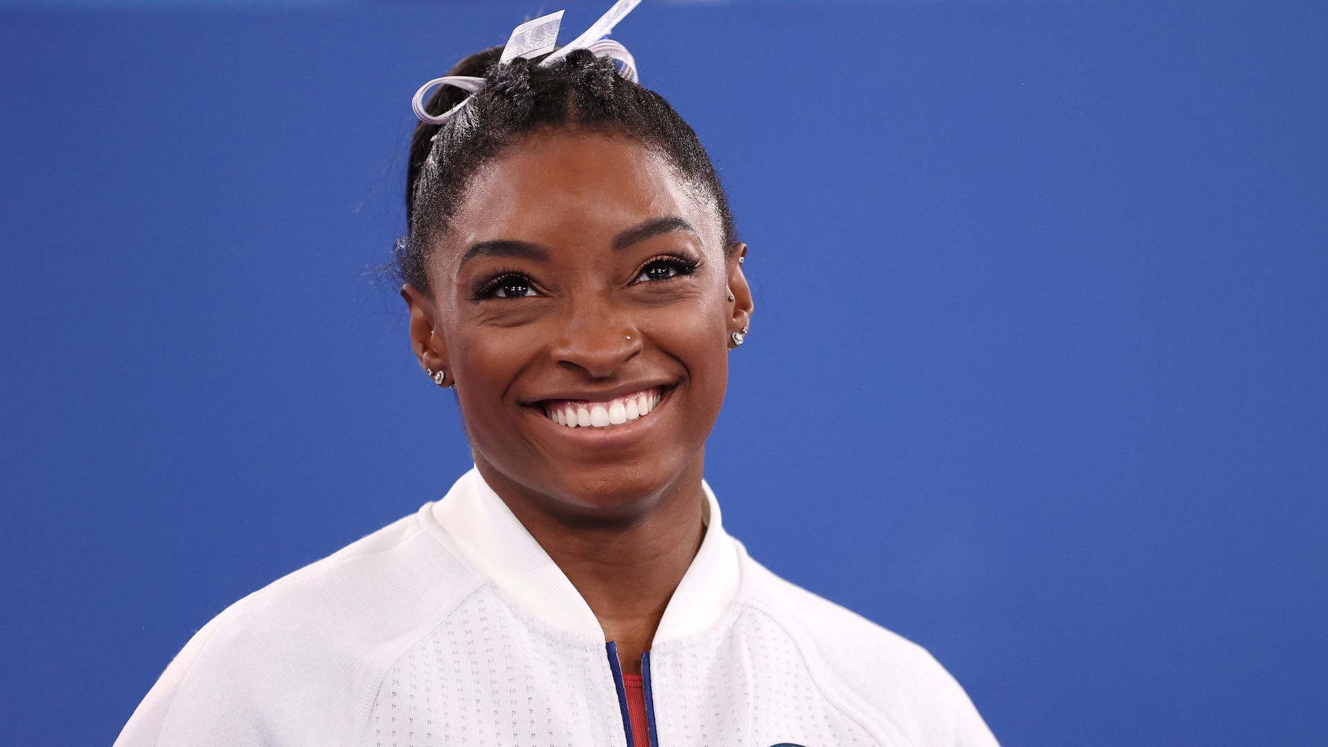 Simone Biles of Team United States smiles during the Women's Team Final on day four of the Tokyo 2020 Olympic Games at Ariake Gymnastics Centre on July 27, 2021 in Tokyo, Japan. (Photo by Laurence Griffiths/Getty Images)