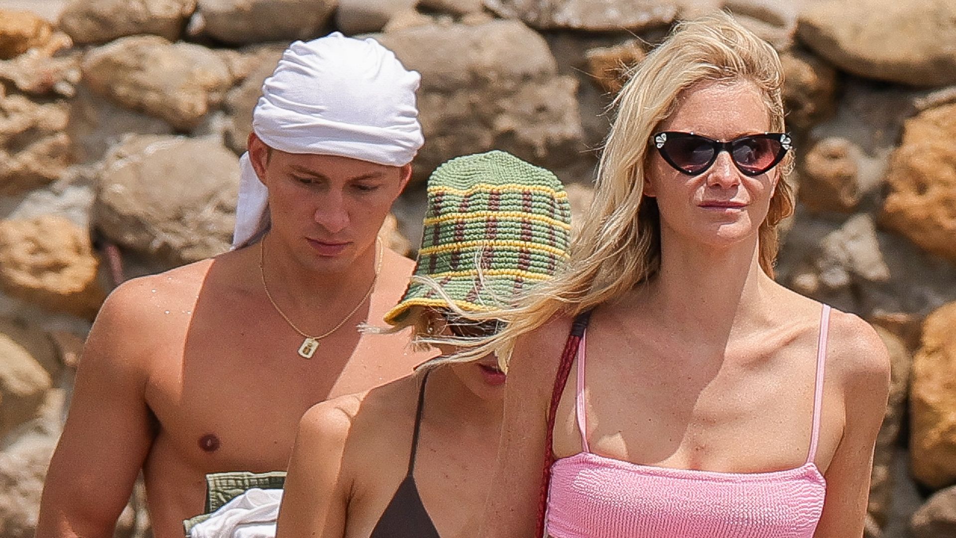 Poppy Delevingne and a shirtless Prince Constantine Alexios walking on a beach