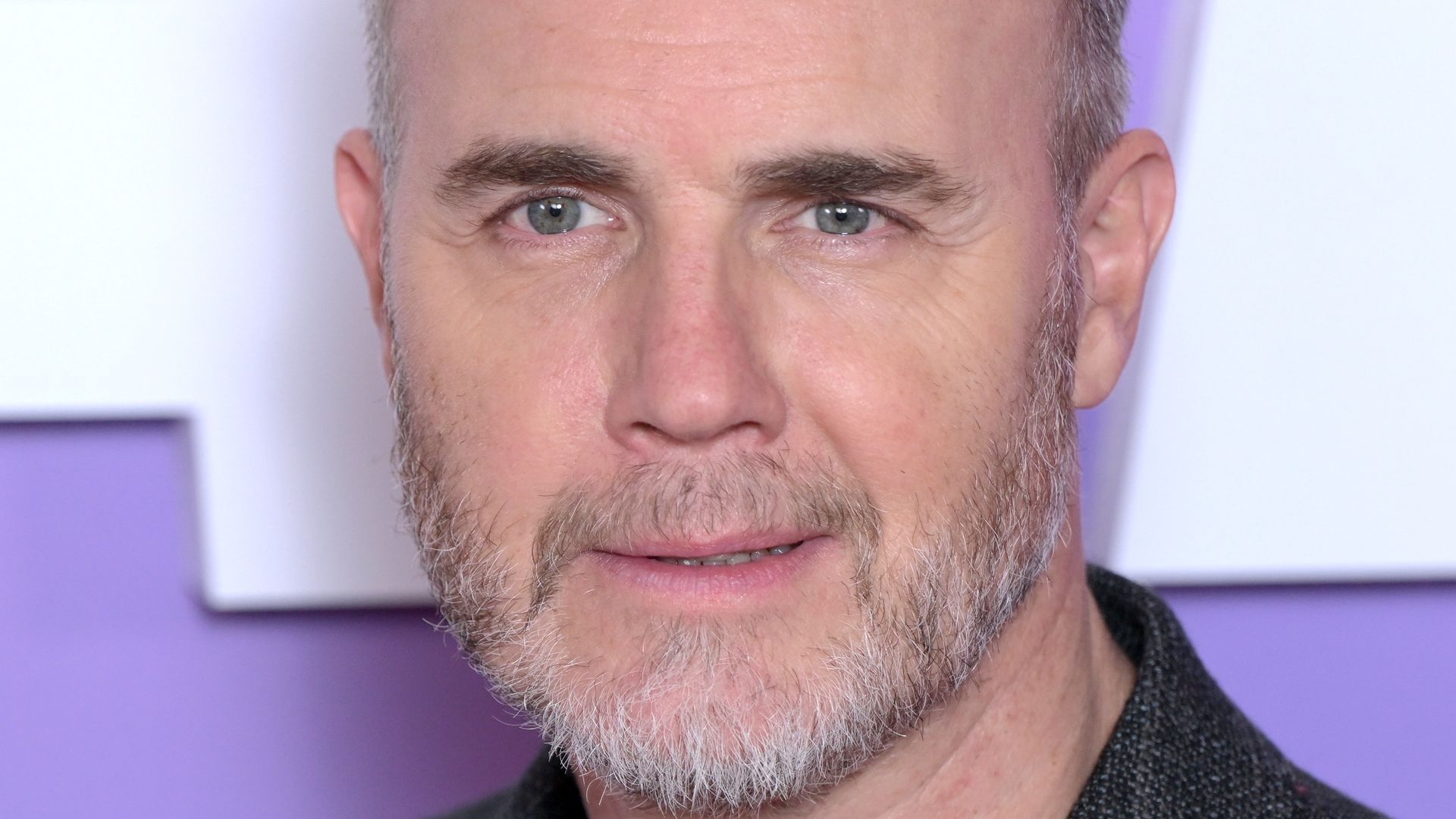 Gary Barlow close up in dark grey blazer