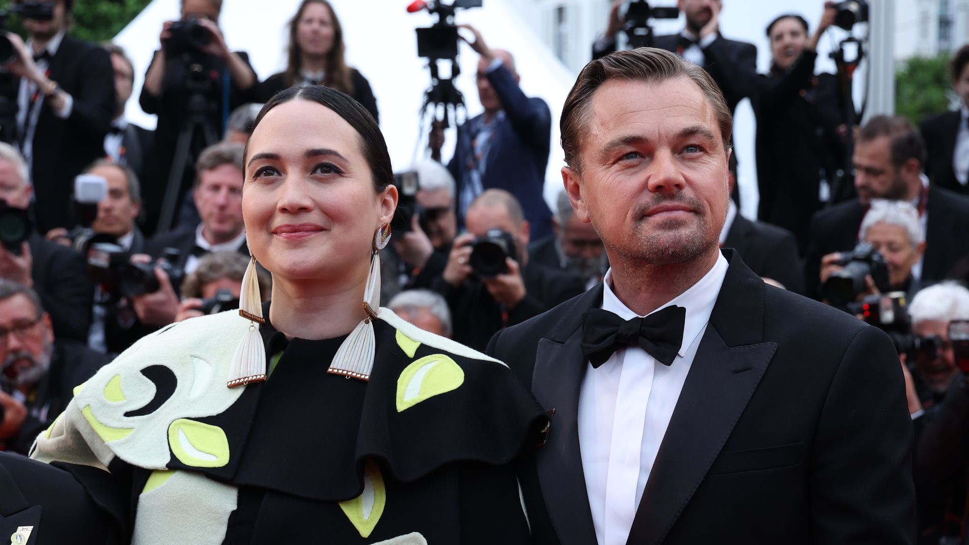 Lily Gladstone and Leonardo DiCaprio attend the "Killers Of The Flower Moon" red carpet during the 76th annual Cannes film festival at Palais des Festivals on May 20, 2023 in Cannes, France