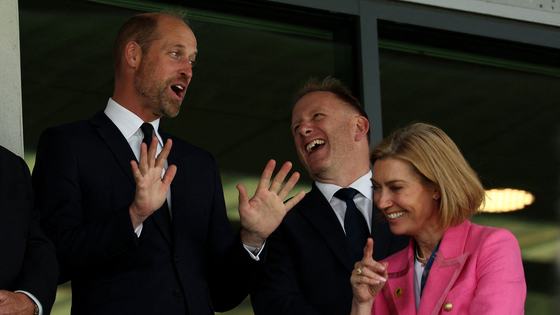 Prince William laughing with his hands out